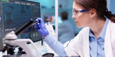 Biochemist scientist working on the laboratory to discovery a technology for a virus. Chemistry research and analysing in science medicine lab developing and stying new type of vaccin